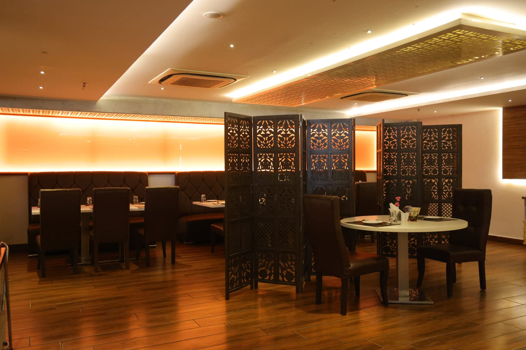 A private dining area screened off with carved wooden partitions