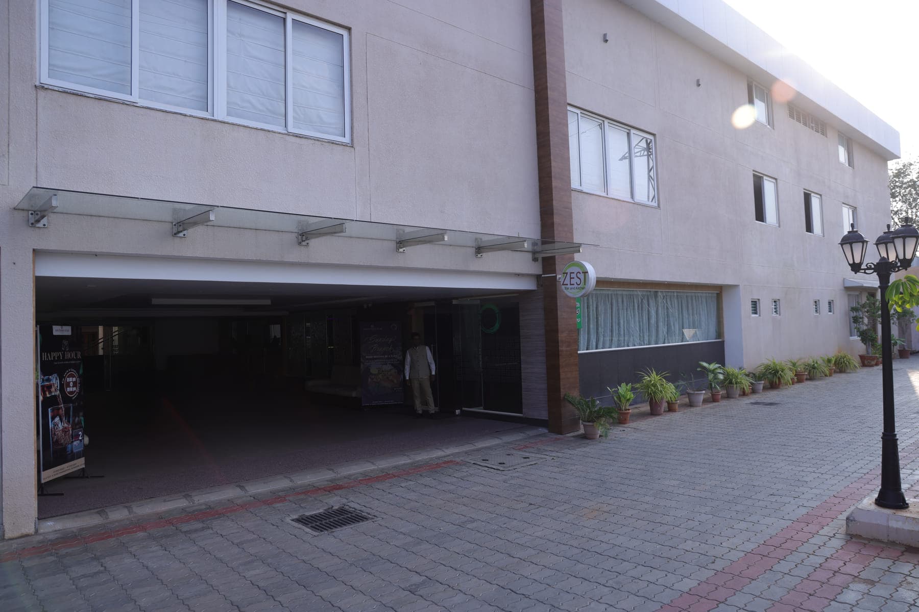The entrance to Hotel Grand Star from the street, with covered parking alongside